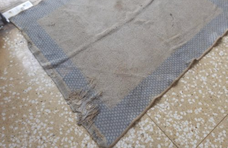 Dirty and worn floor mat