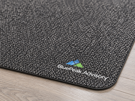 Close-up of Desk Impressions Custom Logo Mat surface texture and logo detail